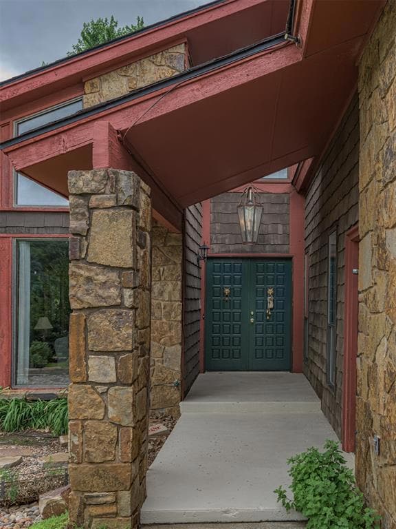 View of exterior entry featuring stone siding