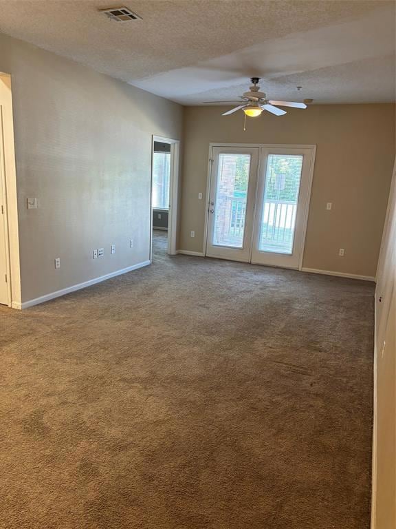 Living room featuring carpet flooring, ceiling fan, and a textured ceiling