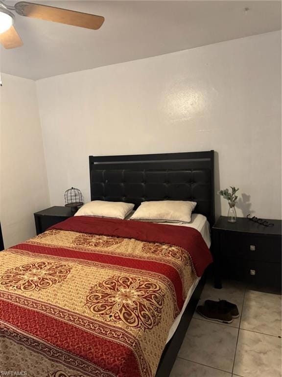 Bedroom with a ceiling fan and tile patterned flooring