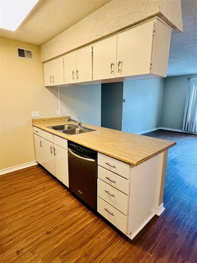 Kitchen with stainless steel dishwasher, a textur