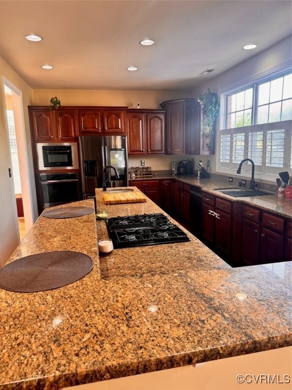 Kitchen with refrigerator, light stone counters, s