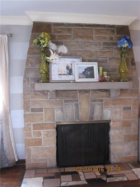 Stone decorative FP with marble hearth in livingro
