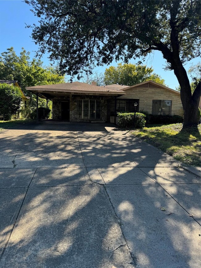 View of front of house with a carport