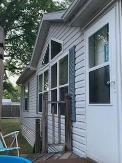 Vaulted wall of living room windows, with the enclosed backyard beyond.