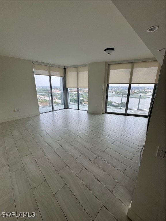 Unfurnished room with floor to ceiling windows and