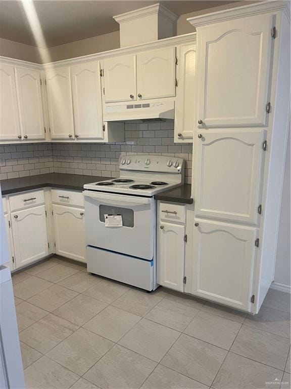 Kitchen featuring electric range, dark countertops, tasteful backsplash, white cabinets, and extractor fan