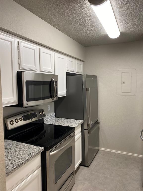 Kitchen view with brand-new Refrigerator