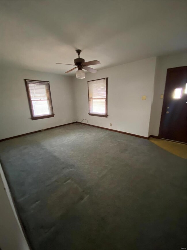 Unfurnished room with baseboards, carpet, and a ceiling fan