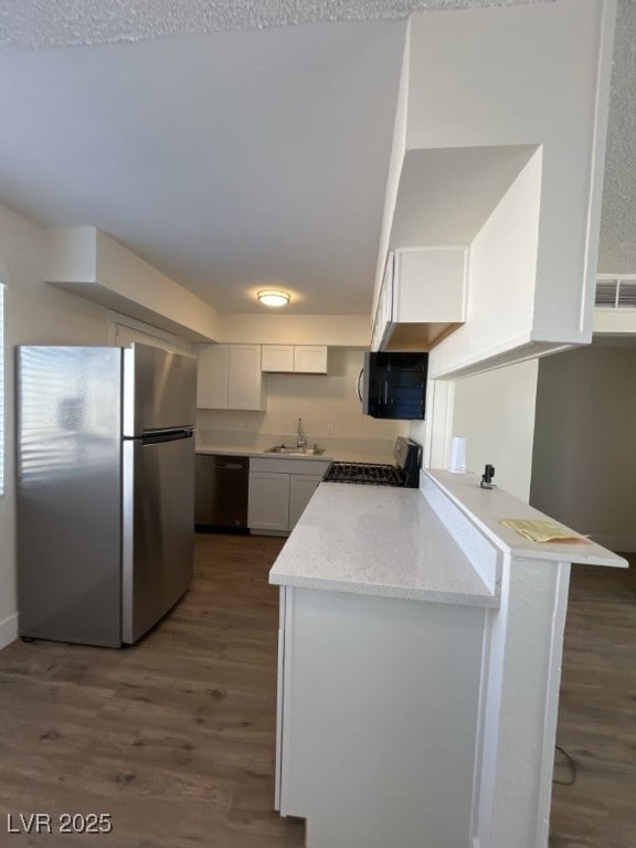 Kitchen with a sink, dark wood-style flooring, a p