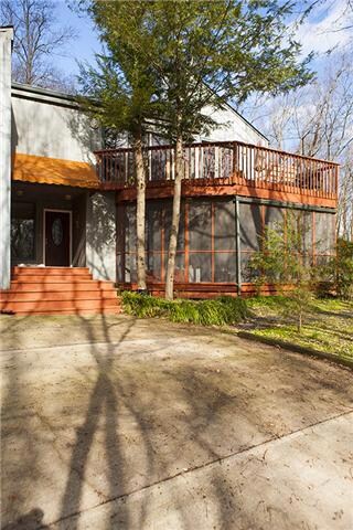The front of the home features the screened in deck and the upper deck. Just 2 of 4 decks on this great home.