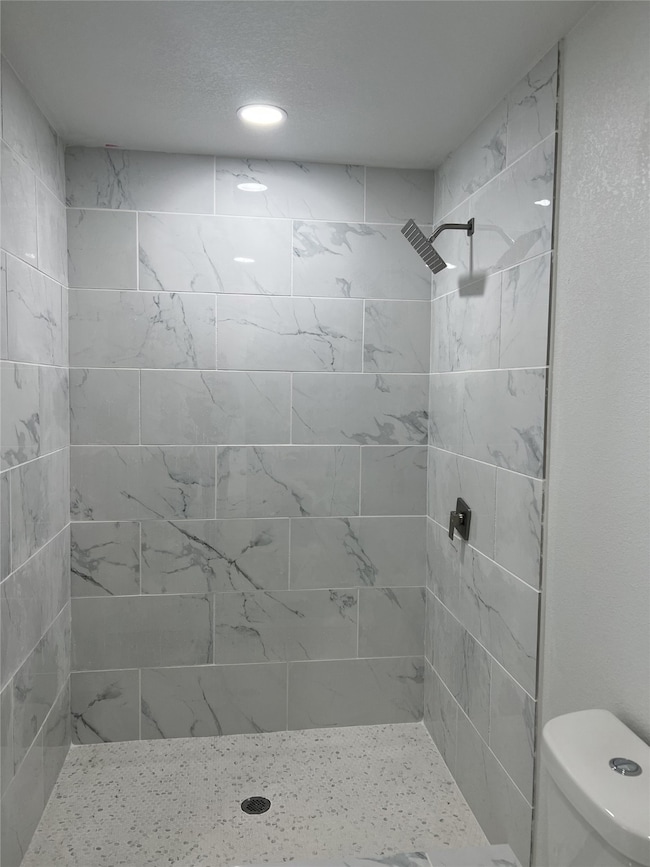 Full bathroom featuring a stall shower