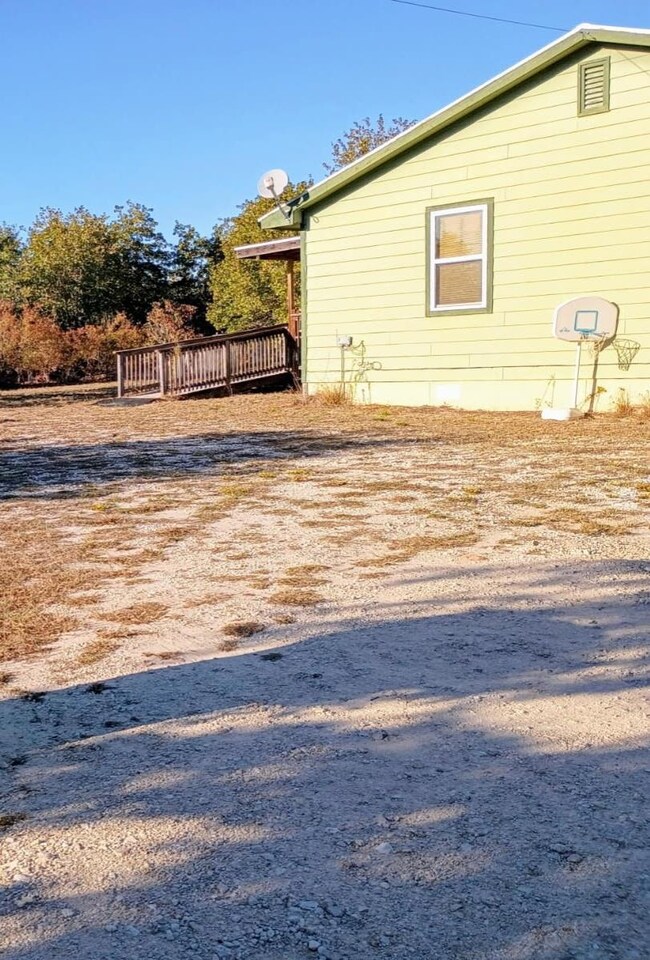 View of property exterior featuring a wooden deck