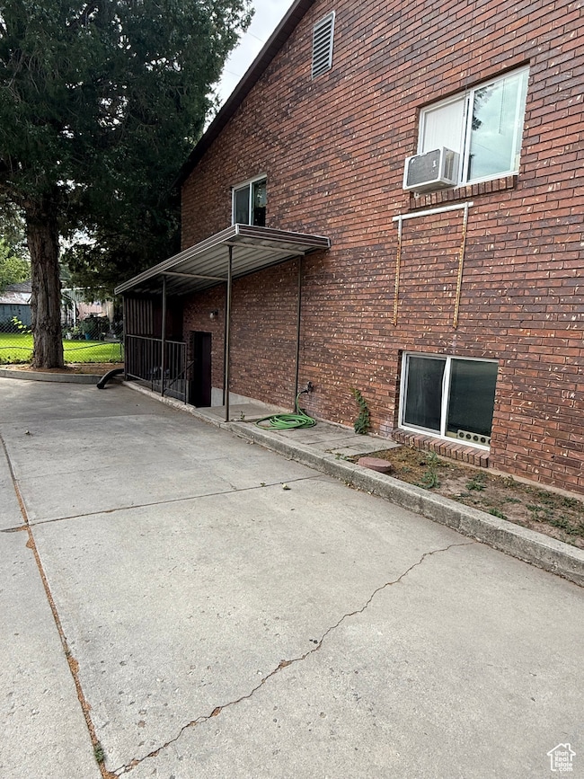 View of Triplex exterior with brick siding