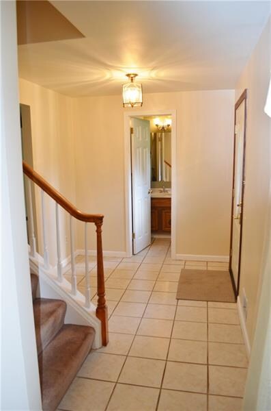 Ceramic entryway with powder room conveniently loc