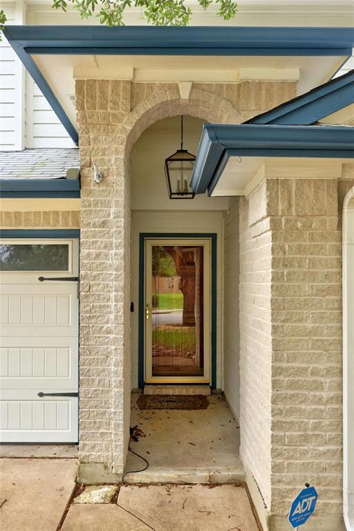 Entrance to property featuring brick siding
