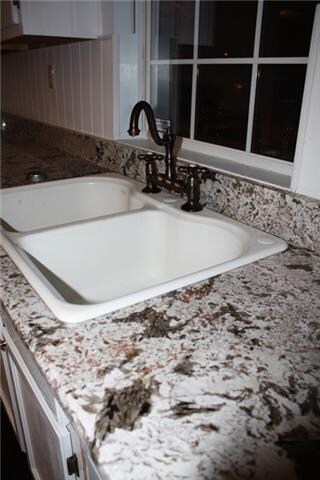 Up close you can see the beautiful farm sink and STUNNING high end granite! You have to see this kitchen!