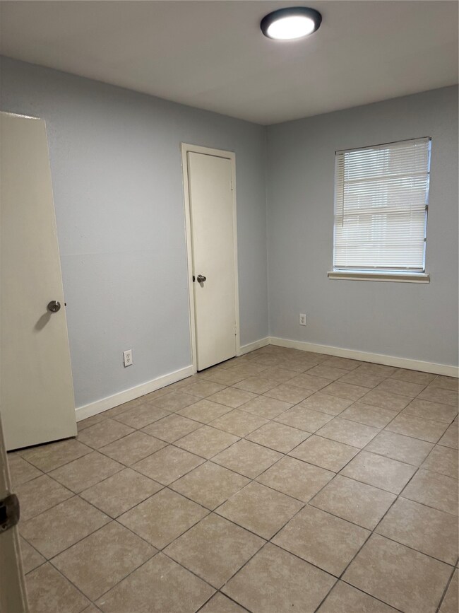 Generous second bedroom with ample natural light.