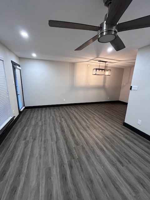 Empty room featuring dark wood-type flooring, recessed lighting, and a ceiling fan
