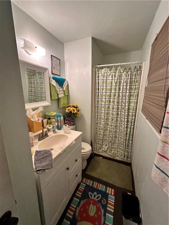 Bathroom with walk in shower, vanity, and toilet