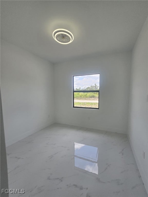 Empty room with light marble finish flooring and b