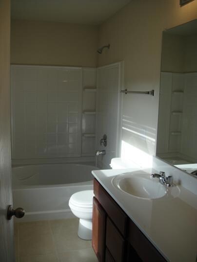 Full bathroom featuring tile floors, shower / bath combination, toilet, and vanity