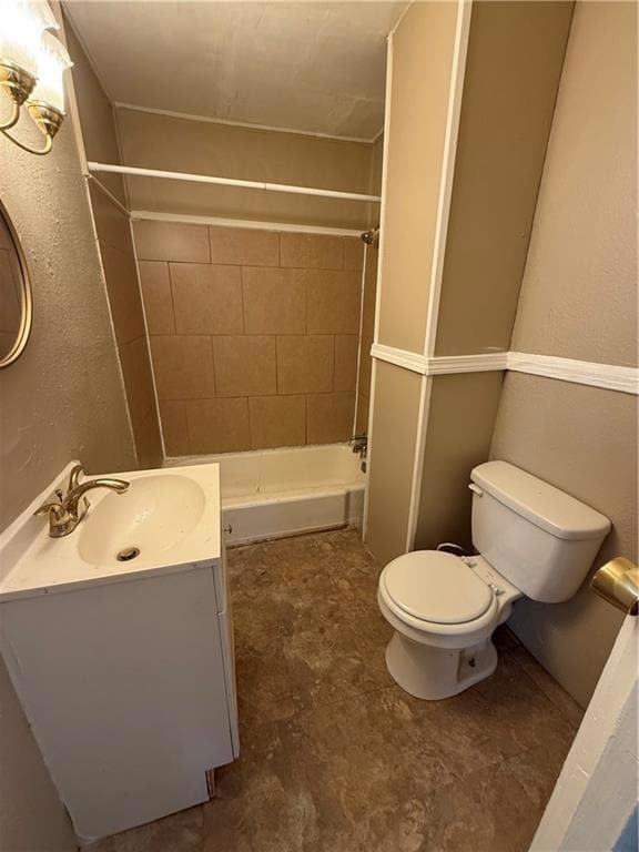 Bathroom with toilet, walk in shower, and vanity