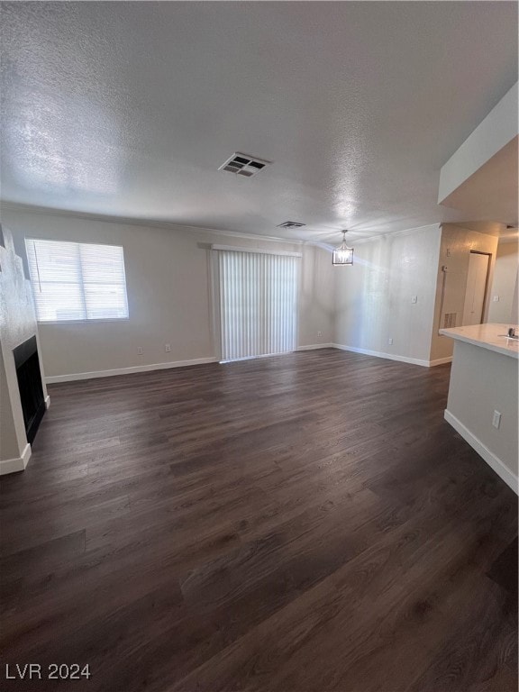 Unfurnished room featuring a fireplace, baseboards
