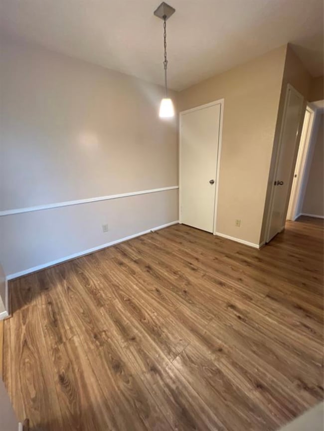 This room features a cozy space with wood laminate