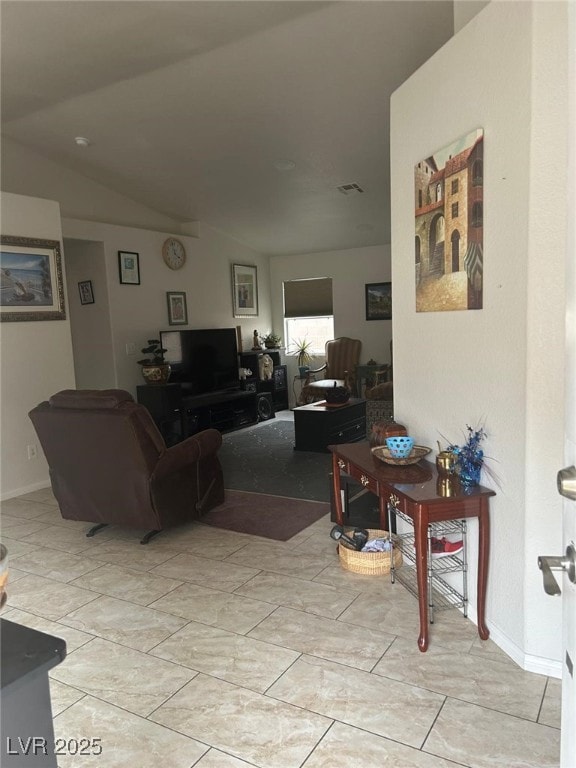 Living room featuring vaulted ceiling, visible ven