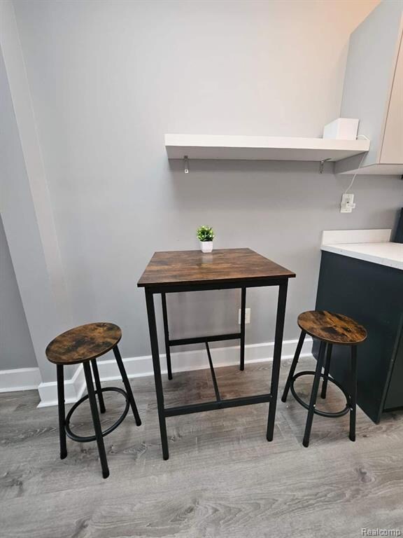Dining space featuring baseboards and light wood-style flooring