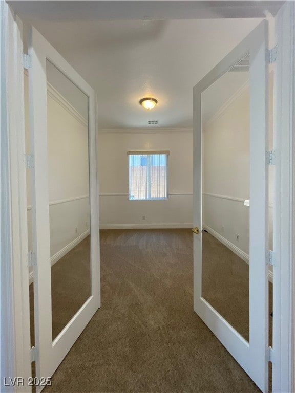 Empty room with carpet floors, crown molding, and
