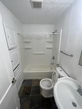 Full bathroom featuring toilet, a sink, bathtub /