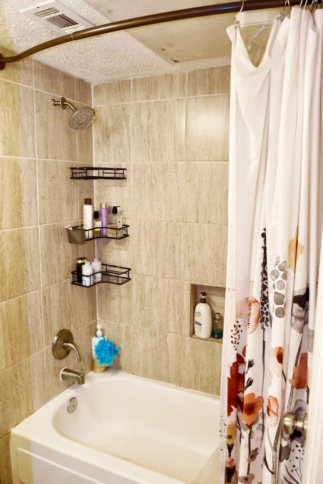 Bathroom featuring shower / bath combo with shower curtain