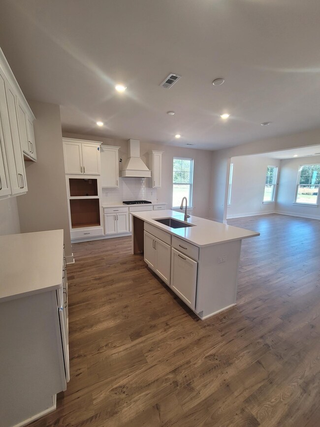 Gourmet kitchen with wood hood