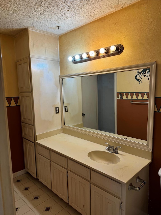Bathroom featuring vanity, tile patterned floors, 