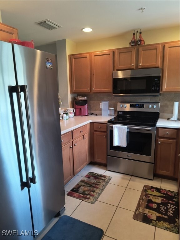 Kitchen with refrigerator, stove, light countertop