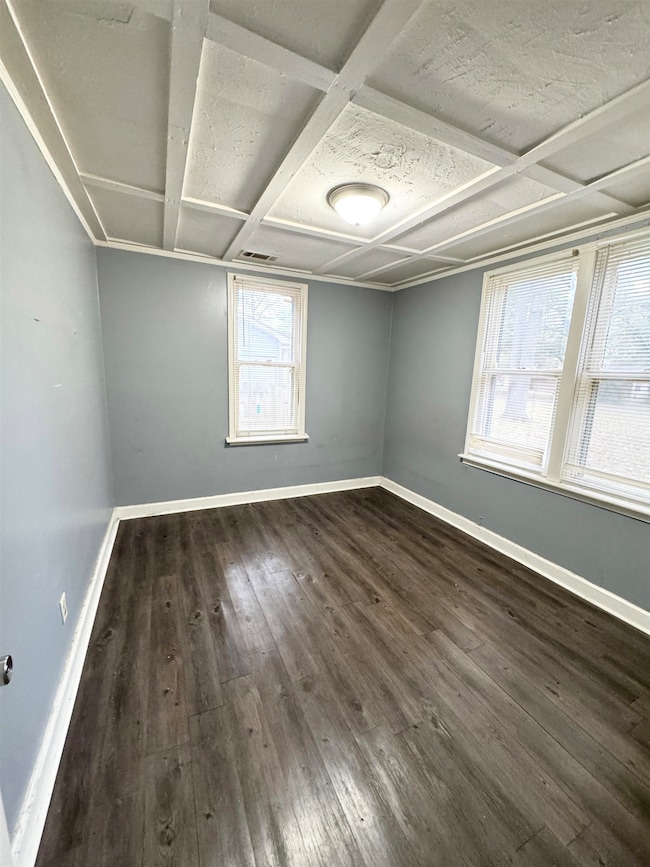 Unfurnished room with dark hardwood / wood-style f