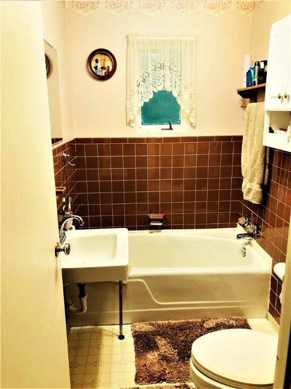 The main floor vintage bathroom is quaint and warm