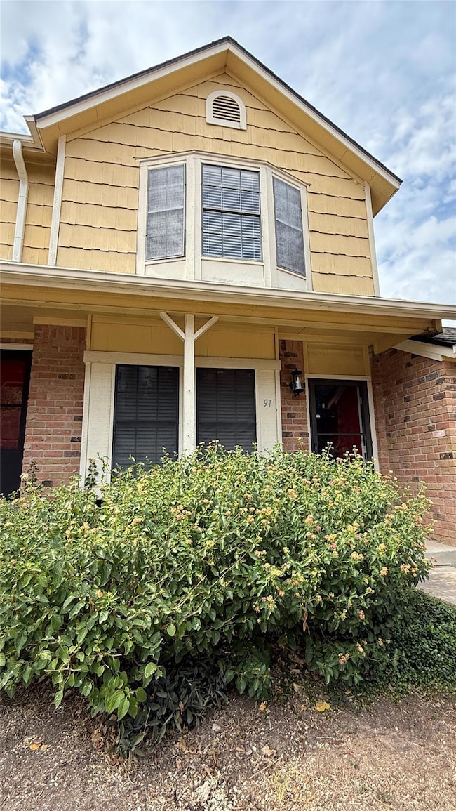 Traditional-style home with brick siding