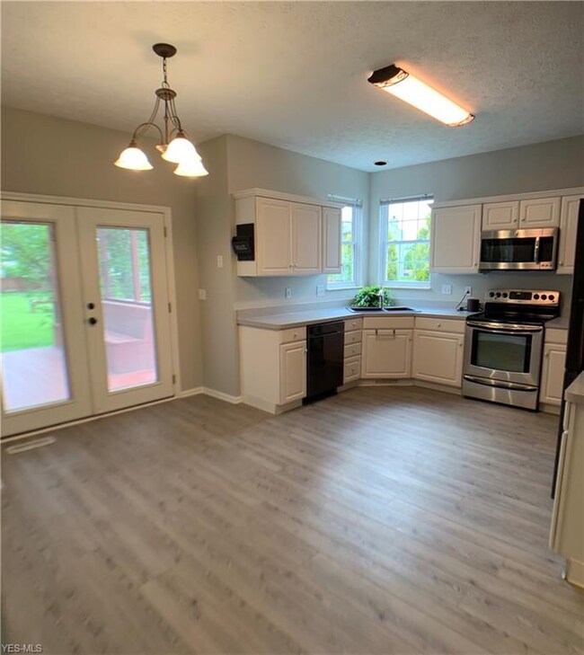 Beautifully updated kitchen with newer flooring, n