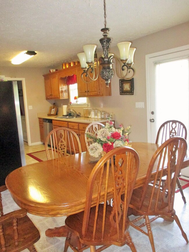 Large dining area with pretty chandelier and patio door