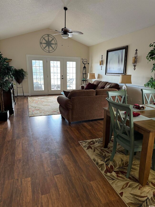 Living room with vaulted ceiling, dark hardwood / 