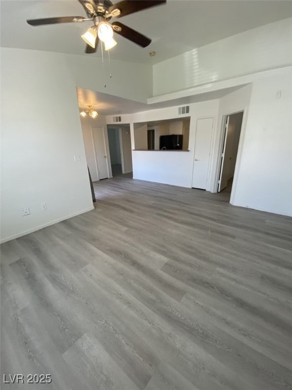 Unfurnished living room featuring wood finished floors and ceiling fan