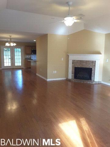 Spacious living room with electric fireplace enhancing ambience.
