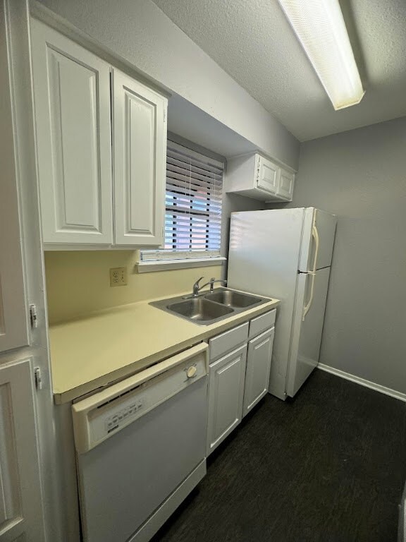 Kitchen with white appliances, a sink, white cabin