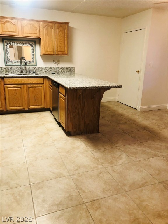 Kitchen with granite counter tops and dishwasher.