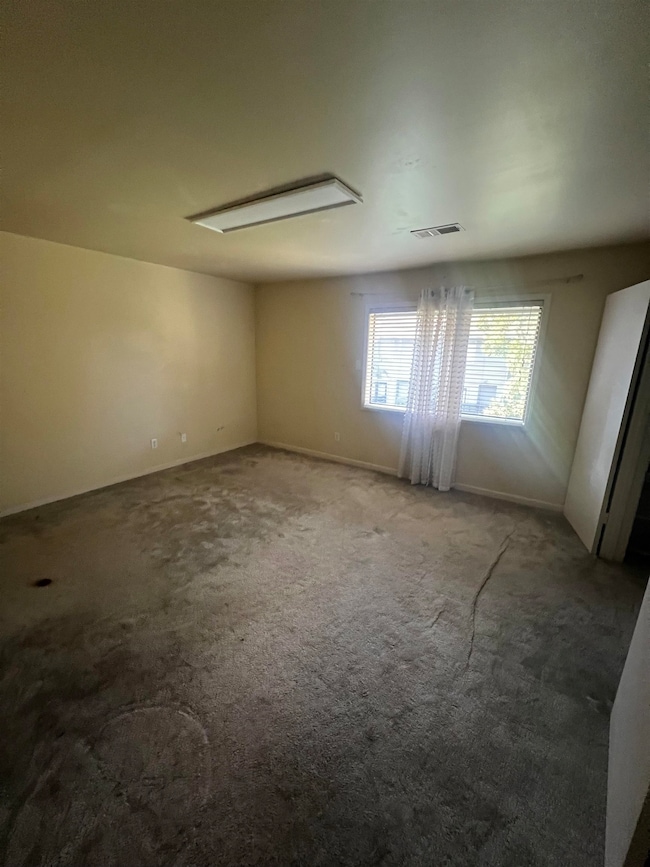 Spare room with carpet floors and attic access