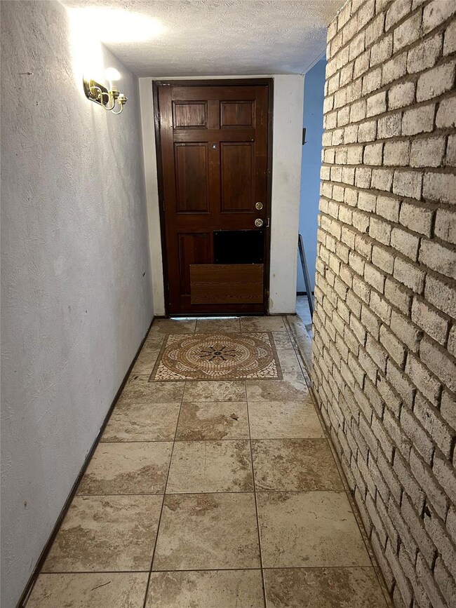 Hallway with light tile patterned flooring