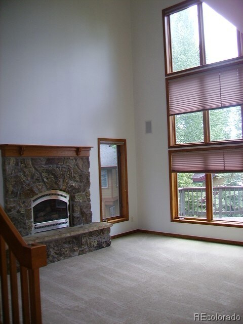 Living room with large windows allowing lots of natural light to enter