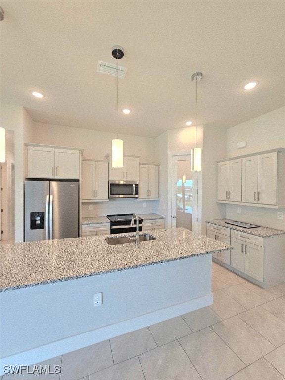 Kitchen with stainless steel appliances, a sink, w